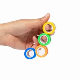 A hand holding four rolls of washi tape in yellow, green, orange, and blue, against a white background.