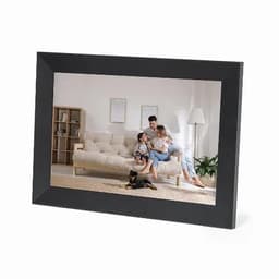 A photo frame in black featuring a family scene with a dog on a rug and a sofa in a bright room.
