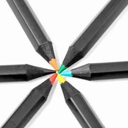 A set of black pencils with tips in orange, green, blue, and yellow arranged in a circular pattern.