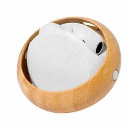 A round product holder in a light wood finish containing white wireless earbuds. It features a logo on the side.