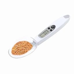 A digital measuring spoon in white, filled with brown seeds, featuring a small display and control buttons.
