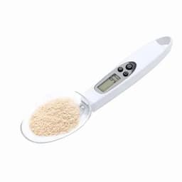 A digital kitchen scale in white, featuring a clear scoop with a fine powder inside, displaying weight on a digital screen.