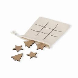 A drawstring bag containing wooden playing pieces shaped like stars and trees, with a printed grid on the bag.