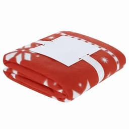 A red fleece blanket with a white snowflake pattern, neatly folded and secured with a white band.