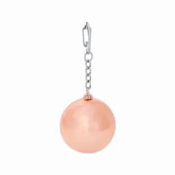 A peach-coloured charm suspended from a silver chain, featuring a shiny spherical design.