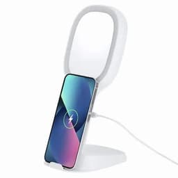 A phone charging stand in white with a curved design, featuring a smartphone positioned for wireless charging.