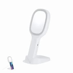 A white vanity mirror with a stand and a small multi-coloured cylindrical object beside it. The mirror has a touch of branding.