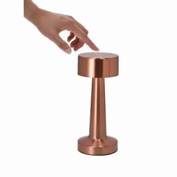 A copper-coloured drink bottle with a sleek, modern design and a hand reaching toward it.