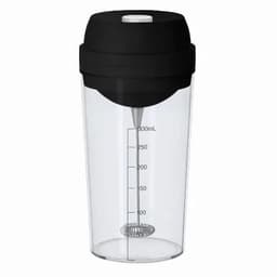 A drink bottle with a clear body and black lid, featuring measurement markings and a whisk ball inside.