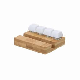 A bamboo docking station with four white key-shaped holders for organising items.