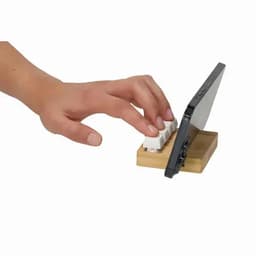 A smartphone stand feature with a hand resting on a mini keyboard, set on a wooden base.