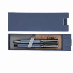 A pen set in a navy blue box, featuring two blue pens with silver accents and a beige card inside.