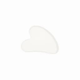 A heart-shaped, translucent white cosmetic tool with a textured surface. It features a simple design with no visible branding.