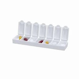 A pill organiser with seven compartments, each containing a different coloured capsule or tablet, all in white plastic.