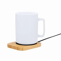A white mug on a wooden base with a black power cord. The base has a round indentation for the mug.