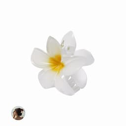 A hair clip shaped like a white plumeria flower with a yellow centre, featuring a logo.