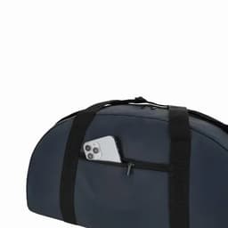 A bag in dark blue with black straps featuring a zipped pocket holding a smartphone.