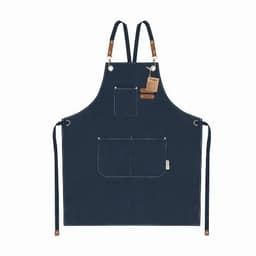 A navy blue apron with leather straps and front pockets, featuring a label and stitching details.