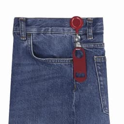 A pair of blue denim jeans featuring a red zipper pull with a built-in bottle opener.