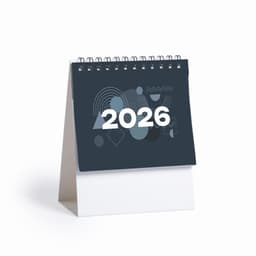 A spiral-bound desk calendar featuring a dark cover with geometric patterns and the year 2026 prominently displayed.