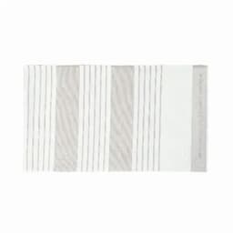 A bath mat featuring a striped design in shades of white and light grey. It has a textured surface and a logo.