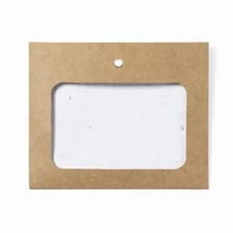 A promotional product package with a clear window, crafted from brown recycled paper, showcases a white item inside.