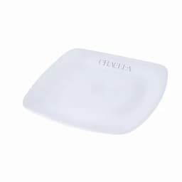 A square white plate featuring a branding logo in one corner.
