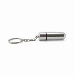 A silver keychain pill holder with a cylindrical design and a chain attachment.