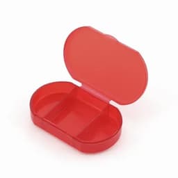 A red pill organiser with two compartments, featuring a hinged lid. It has a transparent design.