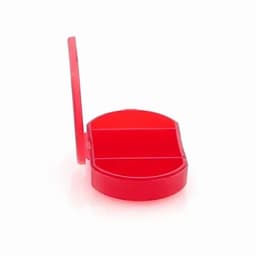 A red pill organiser with a hinged lid and two compartments inside. It has a simple, rounded design.
