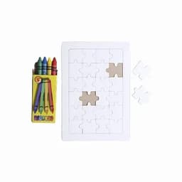 A jigsaw puzzle with several pieces in a white frame, accompanied by a box of colourful crayons.