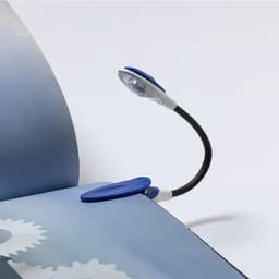 A book light with a flexible neck and a blue clip, resting on an open page of a book.