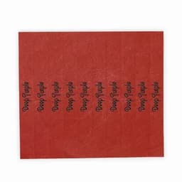 A sheet of deep purple stickers on a red background, featuring repeated text in black.