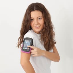 A woman with curly hair is wearing a white shirt and using a black and pink armband for a phone.