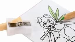 A pencil sharpener with a white body, attached to a sheet featuring a panda illustration and a wooden pencil.
