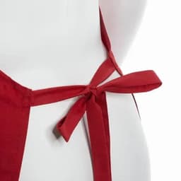 A red apron featuring a tied bow at the back. The fabric appears smooth and durable.