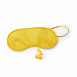 A yellow sleep mask with two yellow earplugs beside it, featuring a smooth, soft material.