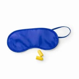 A blue sleep mask with two yellow earplugs positioned nearby. The mask features an elastic strap.