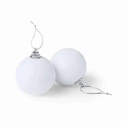 Two white decorative Christmas ornaments with silver hooks for hanging. They are round and textured.