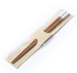 A set of bamboo chopsticks, two in number, packaged with a simple sleeve. The chopsticks are light brown with white tips.
