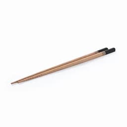Two wooden chopsticks with black tips laid horizontally on a white background.
