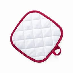 A white quilted pot holder with a red border and a loop for hanging.