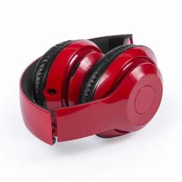 A pair of red headphones with black ear cushions, folded for compact storage.
