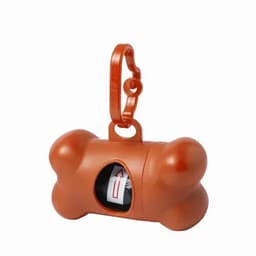 A dog waste bag dispenser in orange, shaped like a bone, with a clip for attachment and a roll of bags inside.