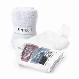 A set of white towels with one featuring a graphic design and a branded label.