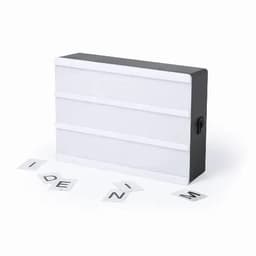A lightbox with a black frame and white panels, accompanied by scattered letters.