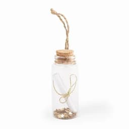 A clear glass bottle with a cork lid, twine, and a scroll inside, featuring decorative materials.