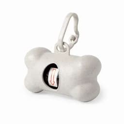 A grey bone-shaped pet accessory with a clip, featuring a compartment for waste bags.