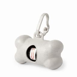 A grey pet waste bag dispenser shaped like a bone, featuring a clip for attachment and an opening for bags.