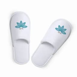 White spa slippers featuring a teal lotus flower design and soft fabric for comfort.